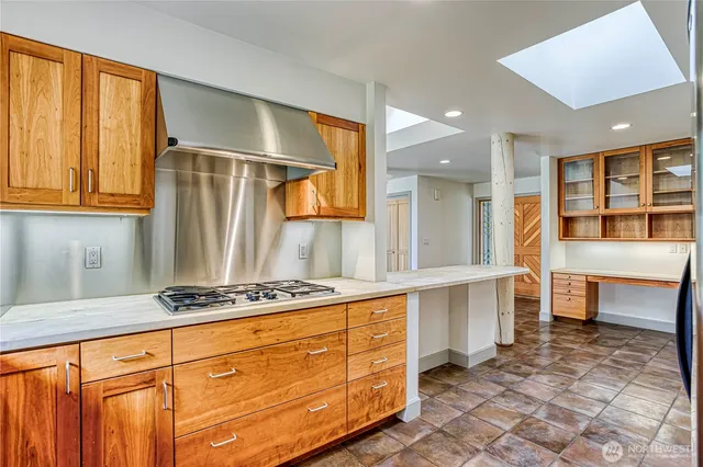 a kitchen with stainless steel appliances granite countertop a sink and cabinets