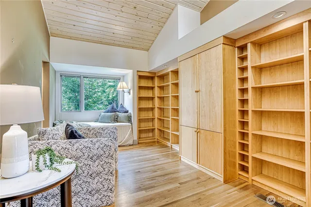 a living room with furniture cabinets and a window