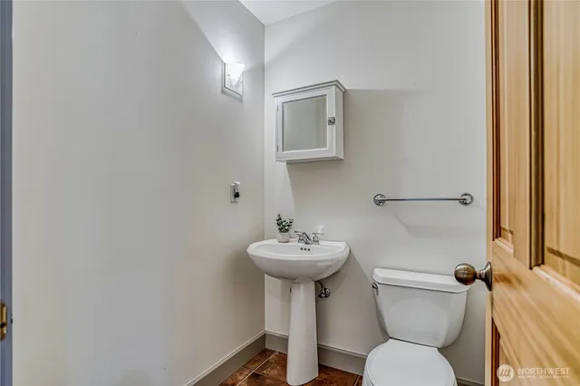a bathroom with a sink mirror toilet and a mirror