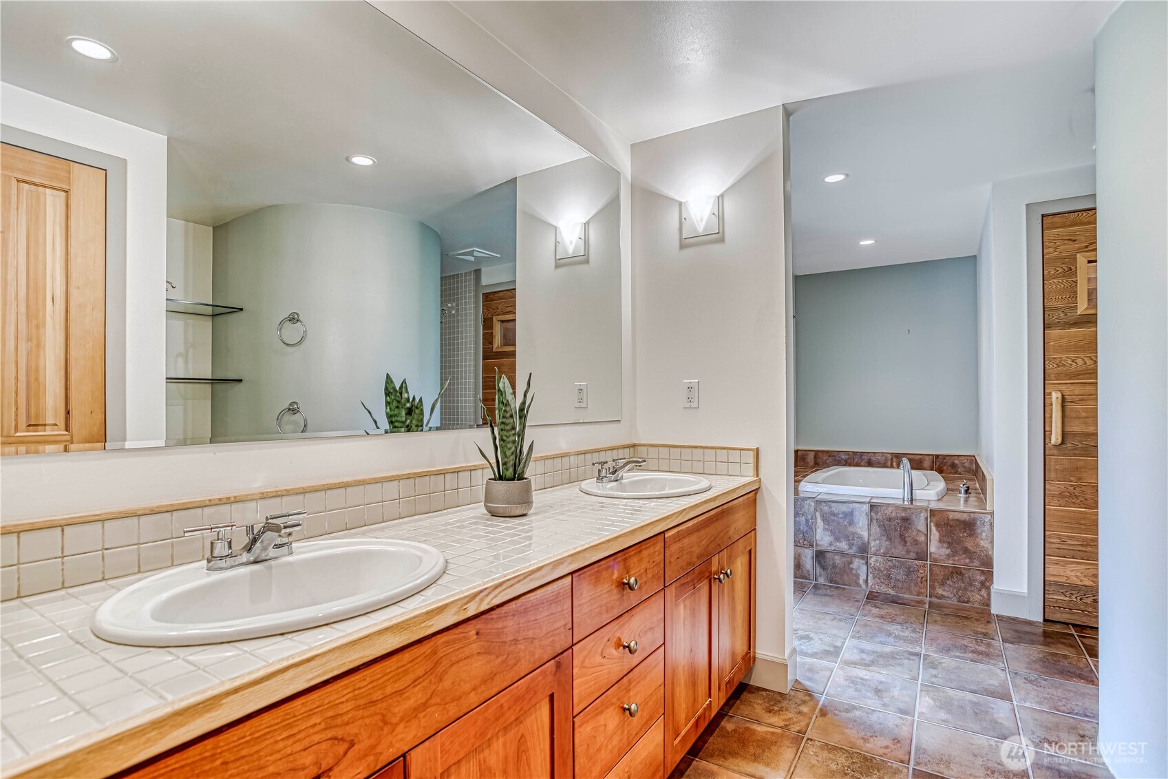 7580 Icicle Road Leavenworth, WA 98826 - Photo 18 of 38 a bathroom with a granite countertop sink and a mirror