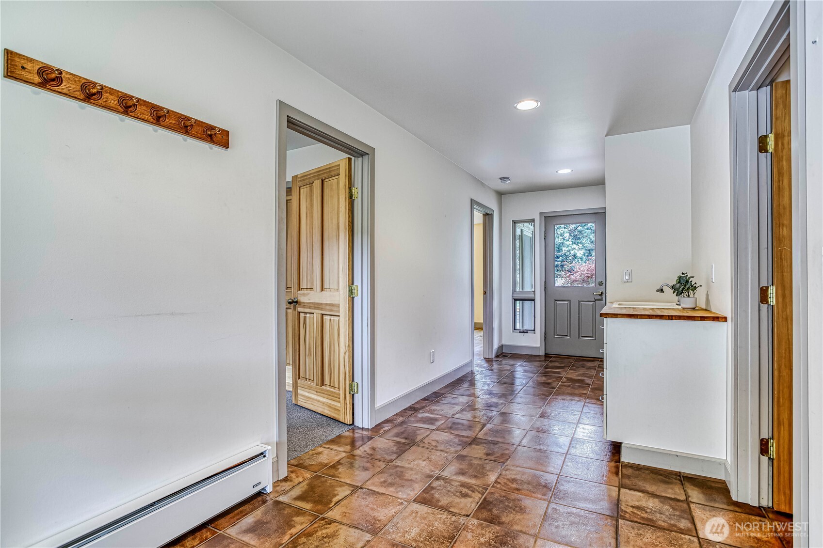 7580 Icicle Road Leavenworth, WA 98826 - Photo 28 of 38 a view of a hallway with wooden floor and a refrigerator