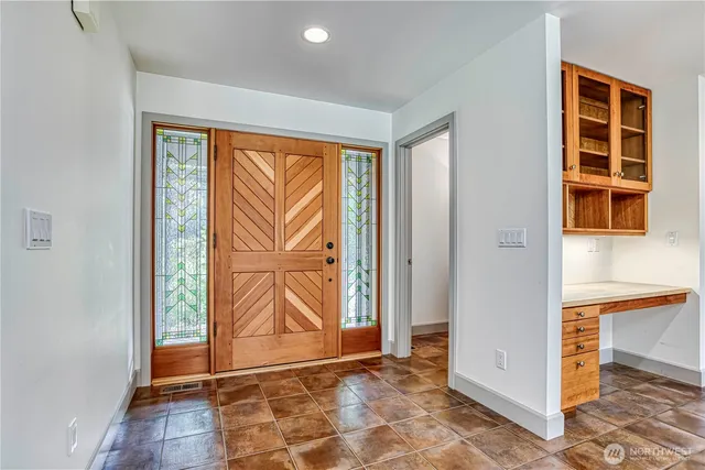 a view of front door with wooden floor