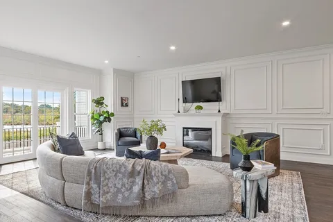 a living room with furniture a fireplace and a flat screen tv