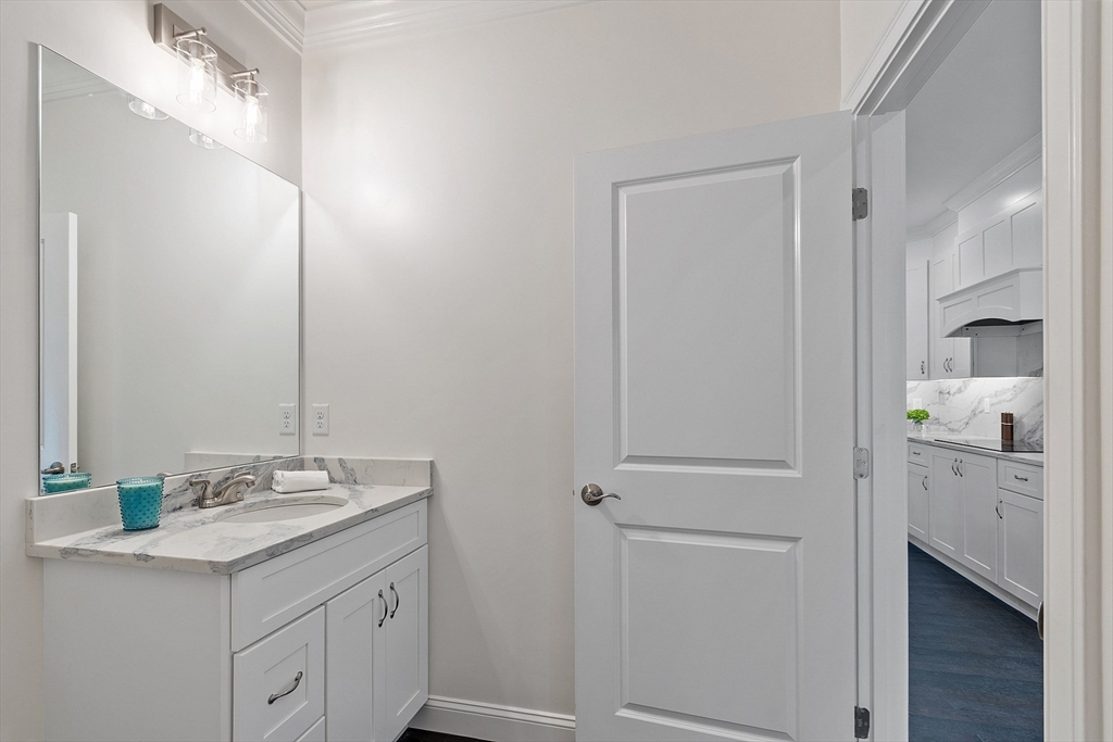206 West Main Street, Unit 8 Georgetown, MA 01833 - Photo 14 of 38 a bathroom with a granite countertop sink and a mirror