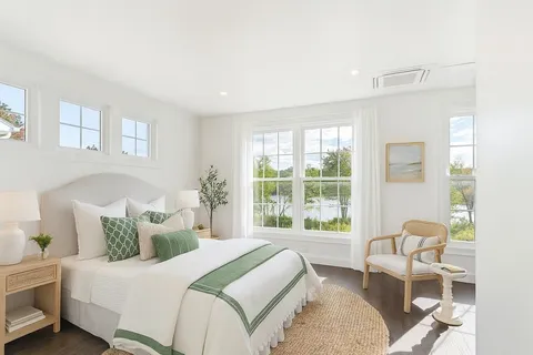 a bedroom with a bed and a large window
