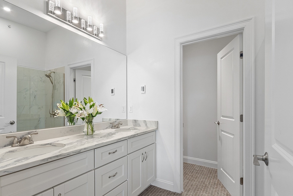 206 West Main Street, Unit 8 Georgetown, MA 01833 - Photo 27 of 38 a bathroom with a granite countertop double vanity and a mirror