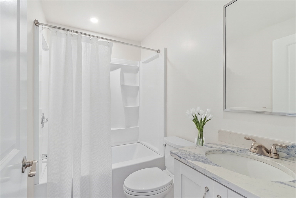 206 West Main Street, Unit 8 Georgetown, MA 01833 - Photo 31 of 38 a bathroom with a granite countertop sink toilet and shower