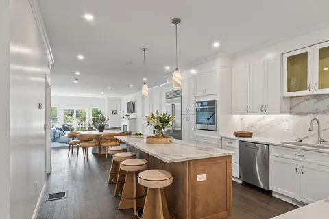 a kitchen with a table chairs stove and kitchen view