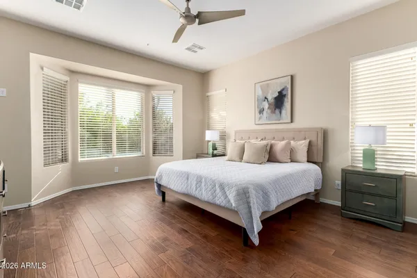 a spacious bathroom with a granite countertop sink a mirror and a shower