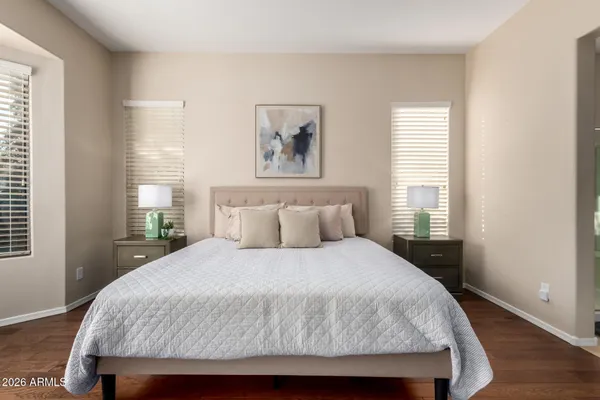 a bed sitting in a bedroom next to a window