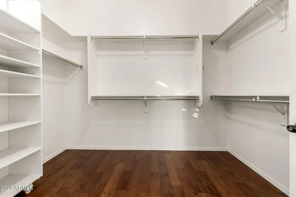 a bedroom with a bed and a flat screen tv in it