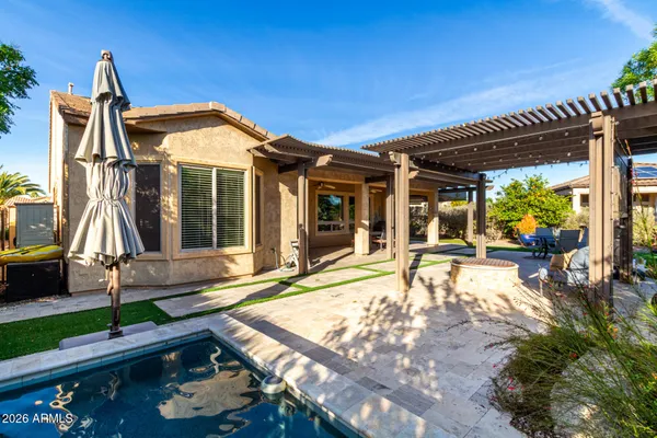 a front view of a house with a yard table and chairs