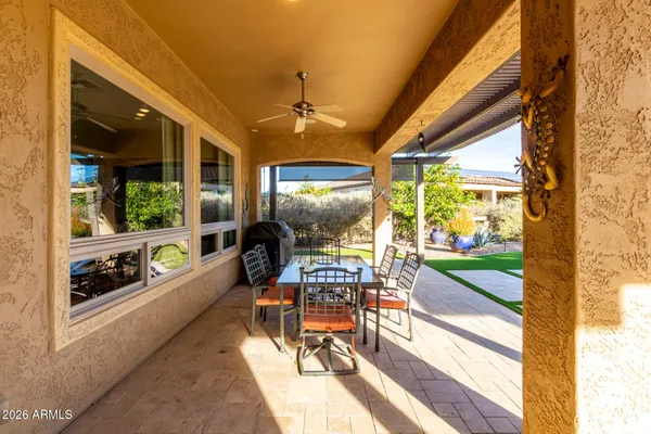 a view of a patio with a dining table and chairs
