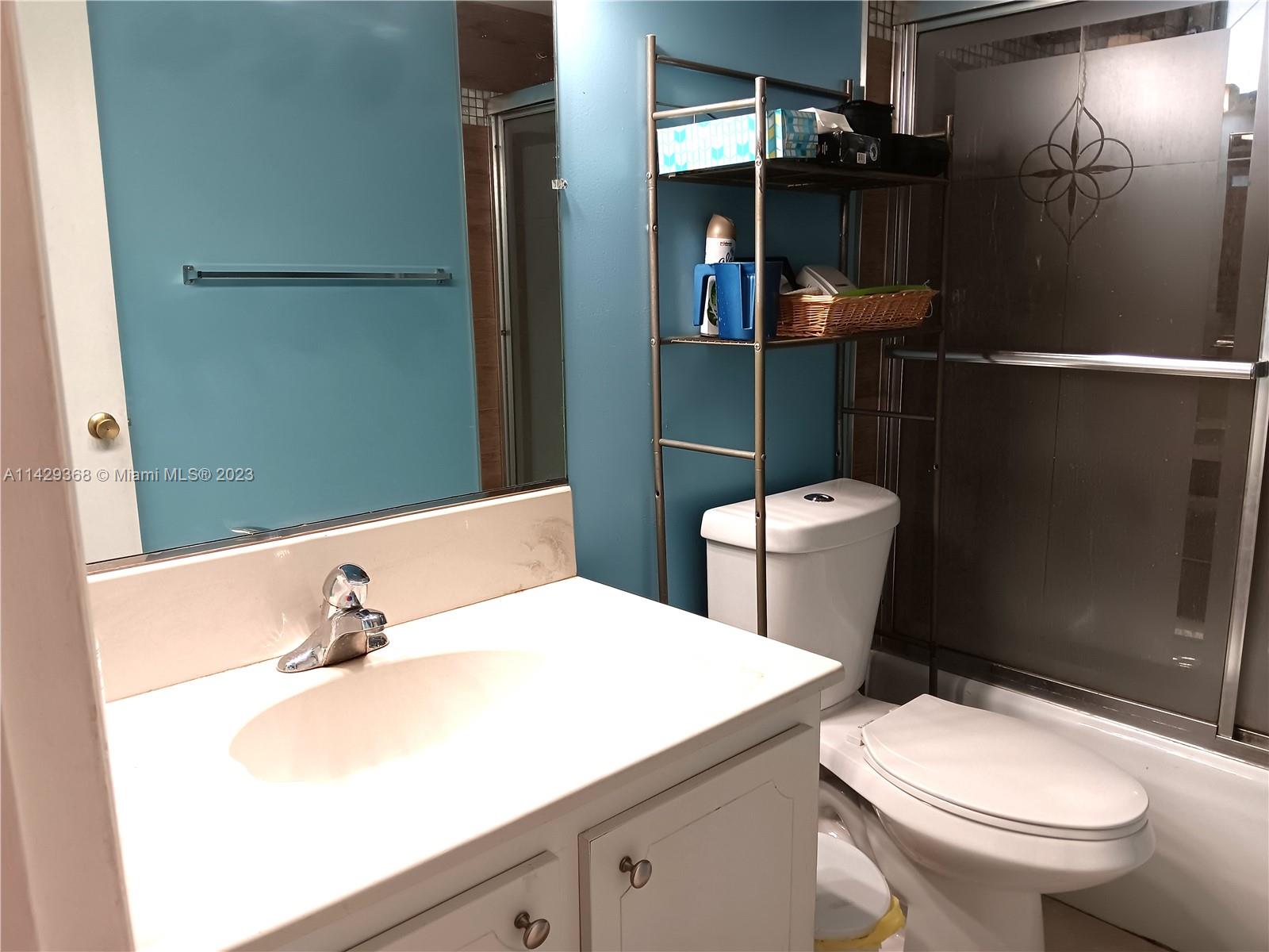 5790 Stirling Road, Unit 311 Hollywood, FL 33021 - Photo 12 of 36 a bathroom with a sink a toilet and shower