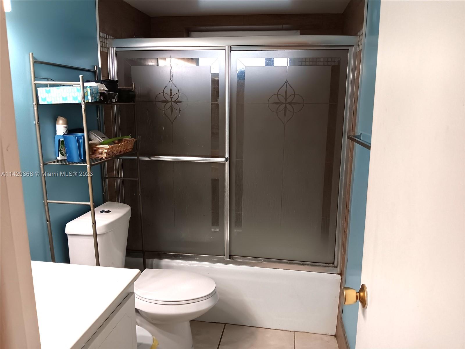 5790 Stirling Road, Unit 311 Hollywood, FL 33021 - Photo 13 of 36 a bathroom with a toilet and a shower