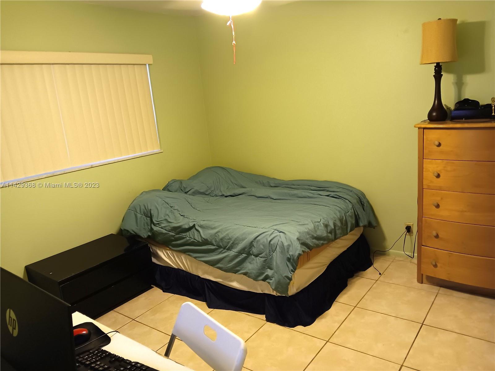 5790 Stirling Road, Unit 311 Hollywood, FL 33021 - Photo 14 of 36 a bedroom with a bed and a window