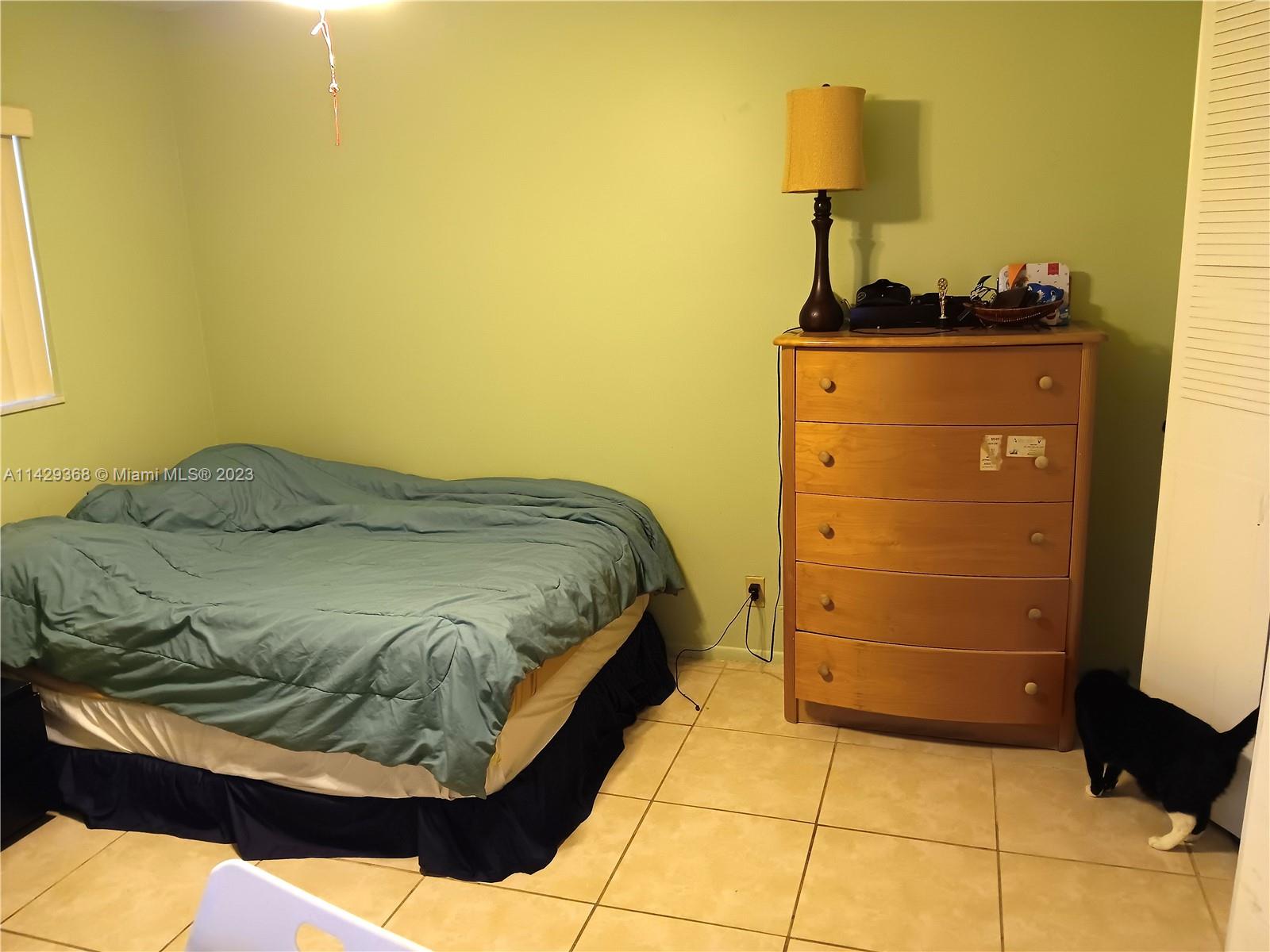 5790 Stirling Road, Unit 311 Hollywood, FL 33021 - Photo 15 of 36 a bedroom with a bed and a dresser