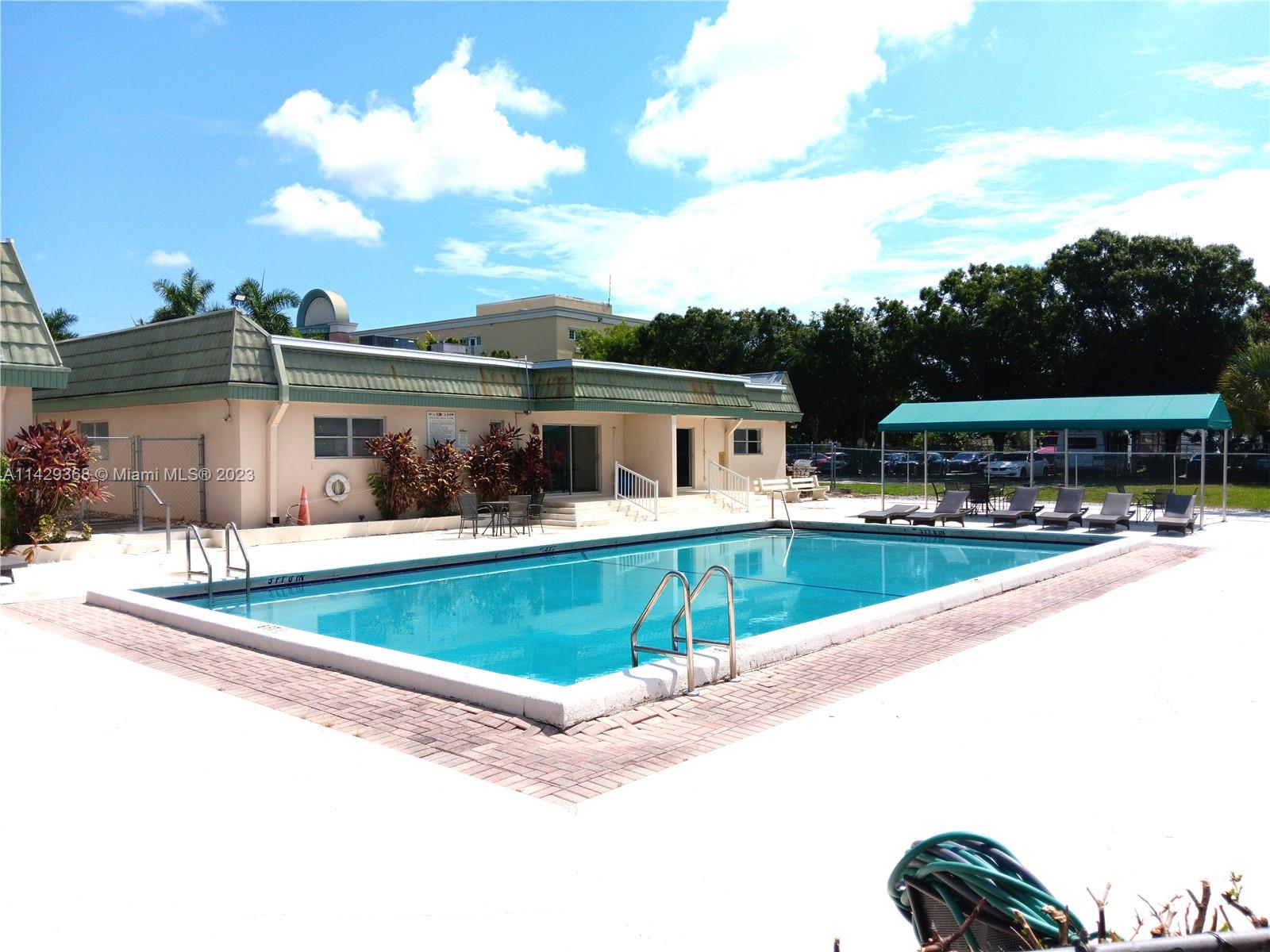 5790 Stirling Road, Unit 311 Hollywood, FL 33021 - Photo 27 of 36 a view of swimming pool with outdoor seating
