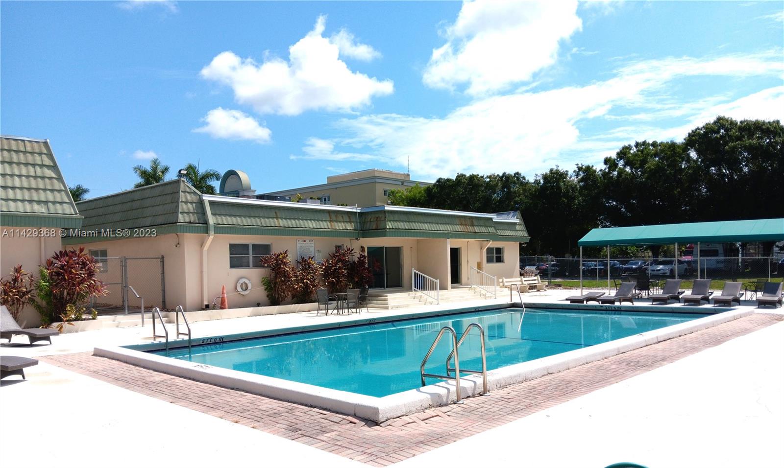 5790 Stirling Road, Unit 311 Hollywood, FL 33021 - Photo 28 of 36 a view of a house with pool and a yard