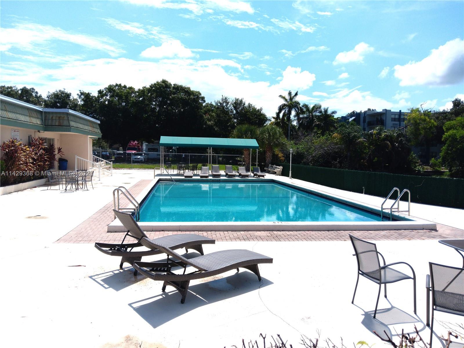 5790 Stirling Road, Unit 311 Hollywood, FL 33021 - Photo 35 of 36 a view of a swimming pool with chairs
