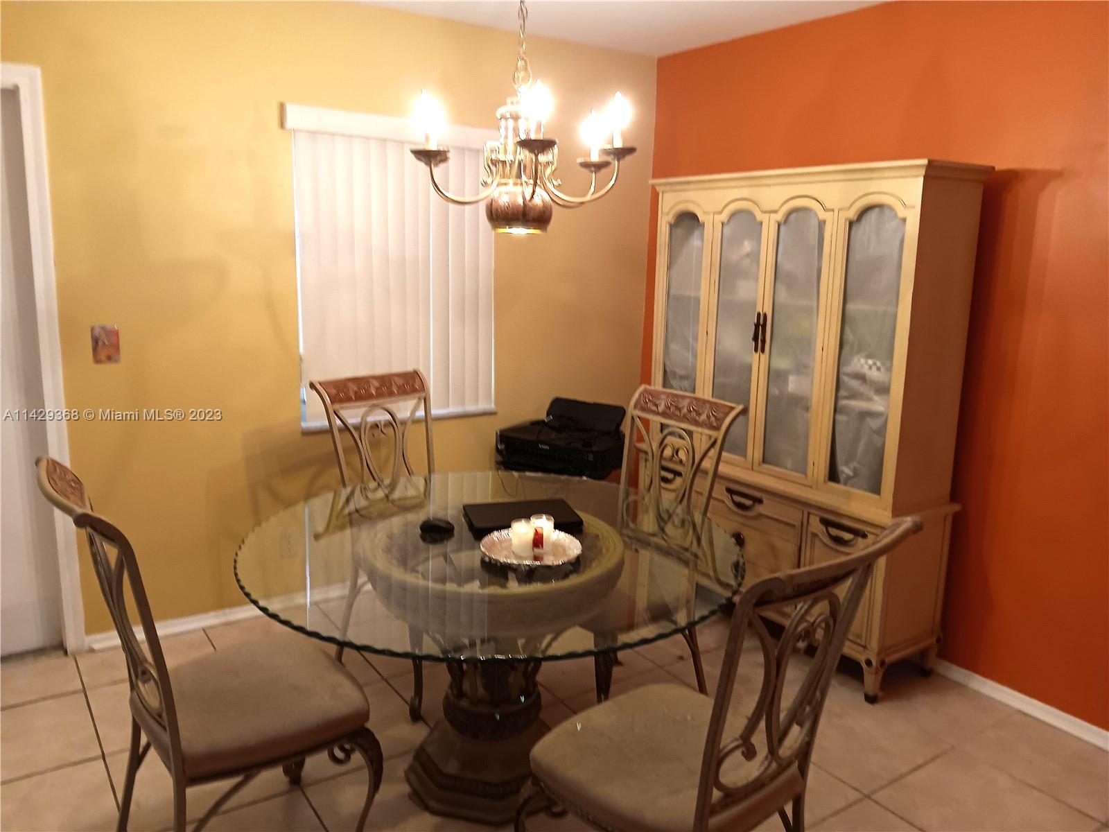 5790 Stirling Road, Unit 311 Hollywood, FL 33021 - Photo 4 of 36 a view of a dining room with furniture and chandelier