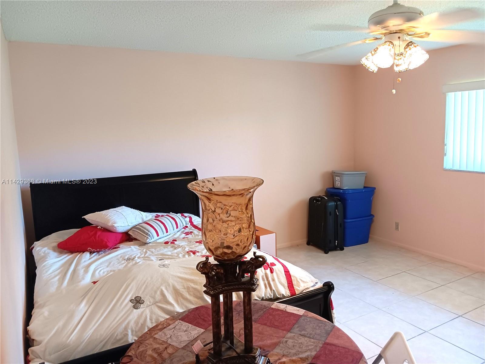 5790 Stirling Road, Unit 311 Hollywood, FL 33021 - Photo 10 of 36 a bedroom with a bed and wooden floor