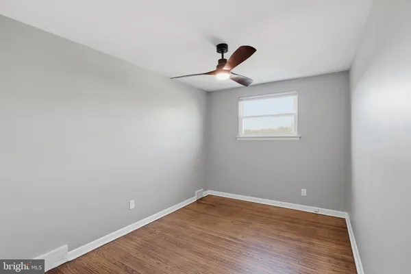 a view of a room with a wooden floor and white walls