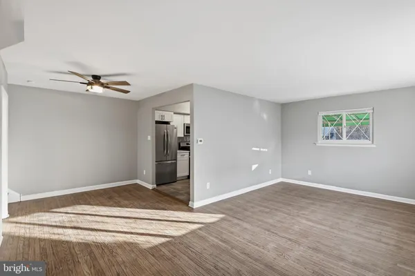 a view of a room with wooden floor and white walls