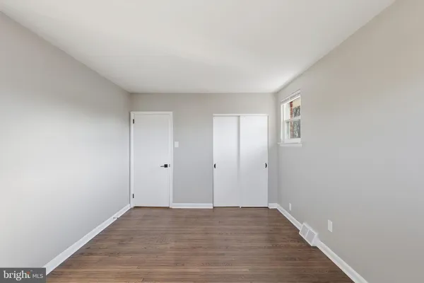 a view of an empty room and wooden floor