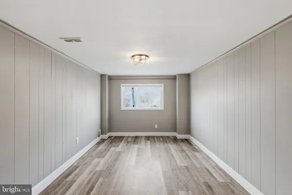 a view of room with window and hardwood floor