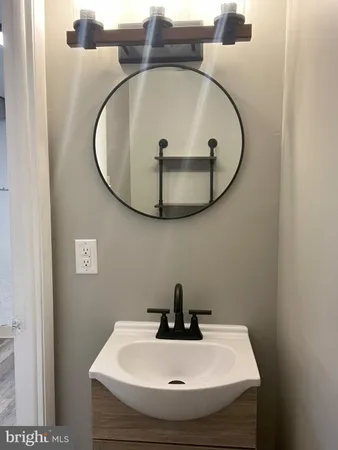 a bathroom with a sink and mirror
