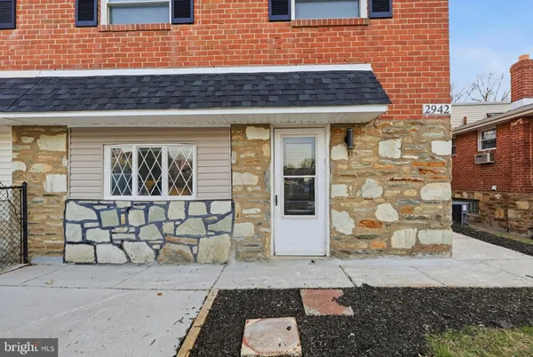 a view of a brick house with an outdoor space