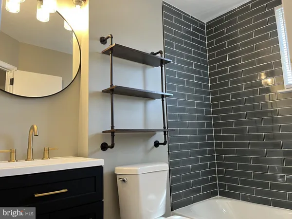 a bathroom with a sink toilet and mirror