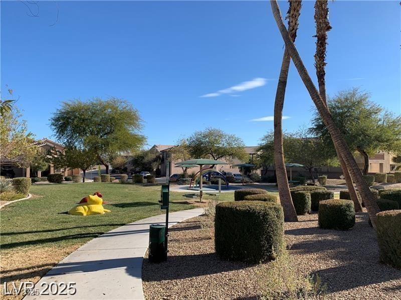 4675 Color Up Court, Unit 101 Las Vegas, NV 89122 - Photo 18 of 19 View of home's community with a lawn