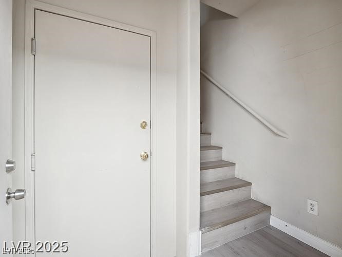 4675 Color Up Court, Unit 101 Las Vegas, NV 89122 - Photo 3 of 19 Staircase with wood finished floors and baseboards