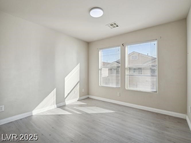 4675 Color Up Court, Unit 101 Las Vegas, NV 89122 - Photo 5 of 19 Empty room with baseboards and light wood finished floors