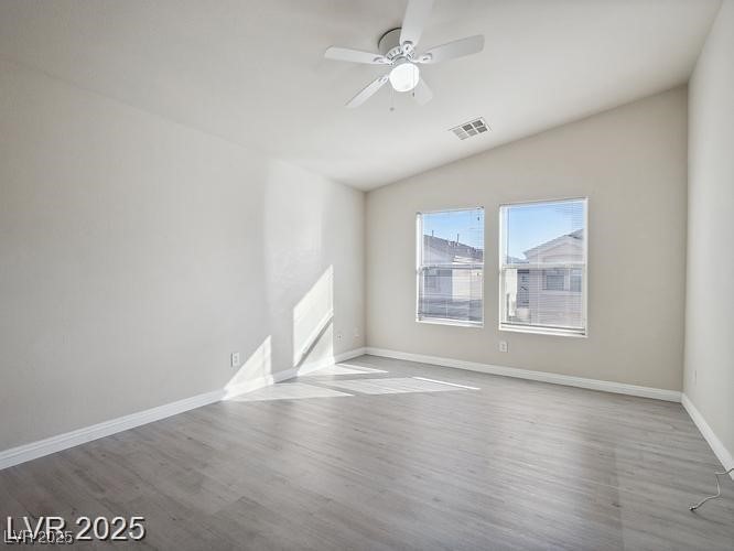 4675 Color Up Court, Unit 101 Las Vegas, NV 89122 - Photo 6 of 19 Unfurnished room with wood finished floors, a ceiling fan, and lofted ceiling