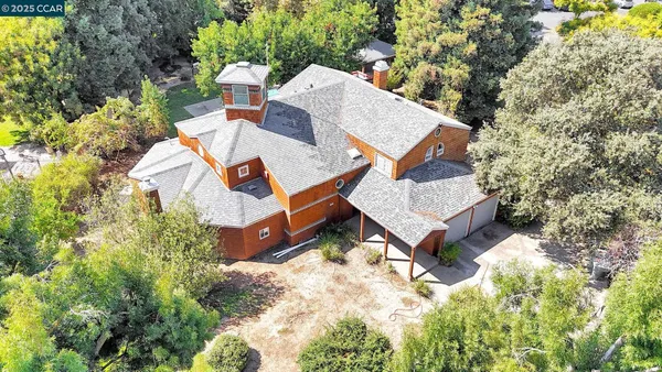 an aerial view of a house with swimming pool and outdoor space