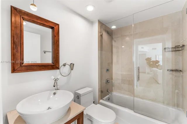 a bathroom with a toilet sink and shower