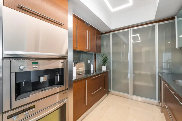 a kitchen with stainless steel appliances granite countertop a refrigerator and a stove