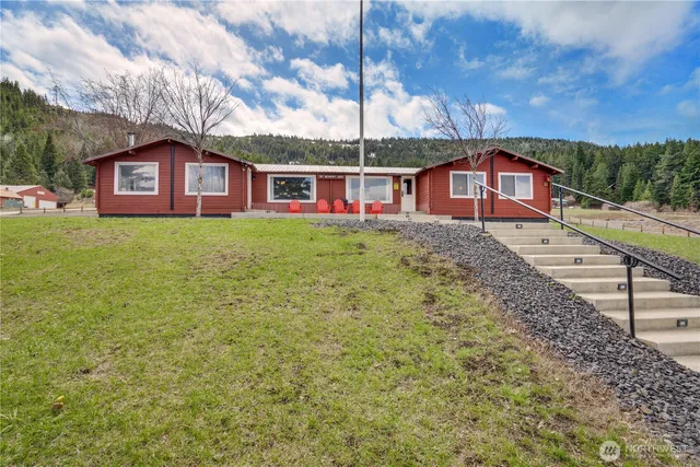 an aerial view of a pool with a yard