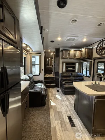 a kitchen with stainless steel appliances a sink and a refrigerator