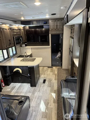 a bedroom with a large bed and large windows