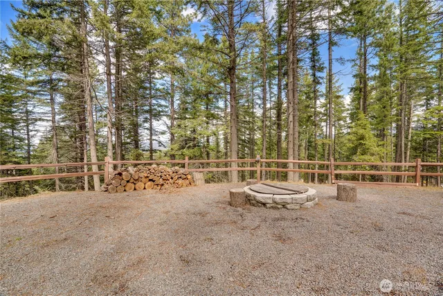 a backyard of a house with table and chairs