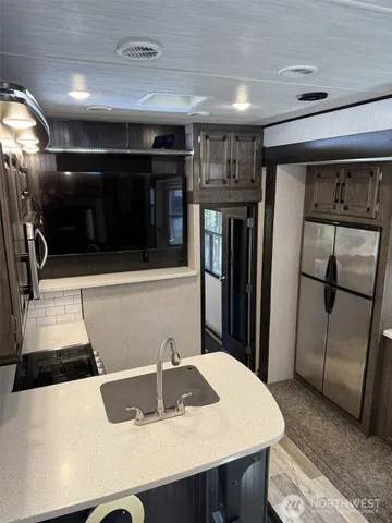 a bedroom with a bed and a television on desk