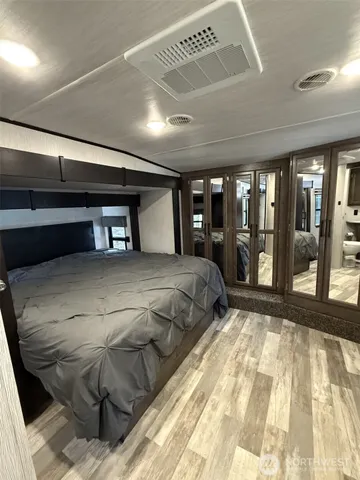 a view of an empty room with wooden floor