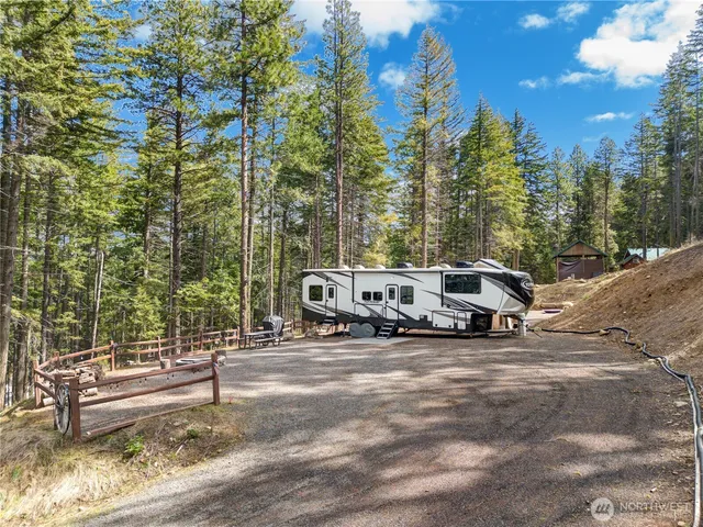 a view of a patio with table and chairs with wooden fence