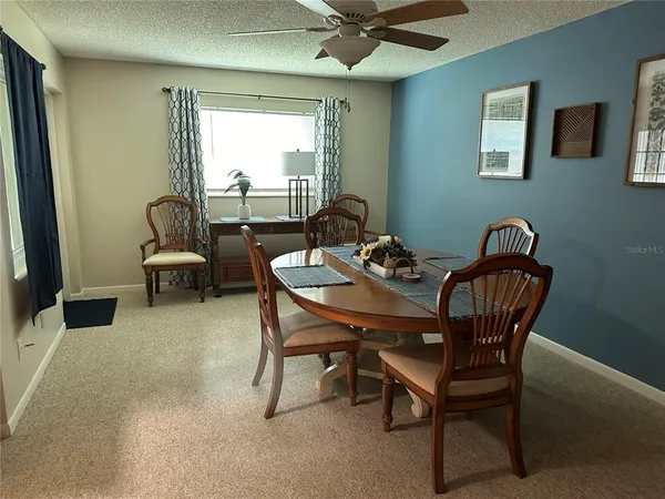 a dining room with furniture and window