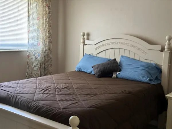 a bedroom with a bed and window