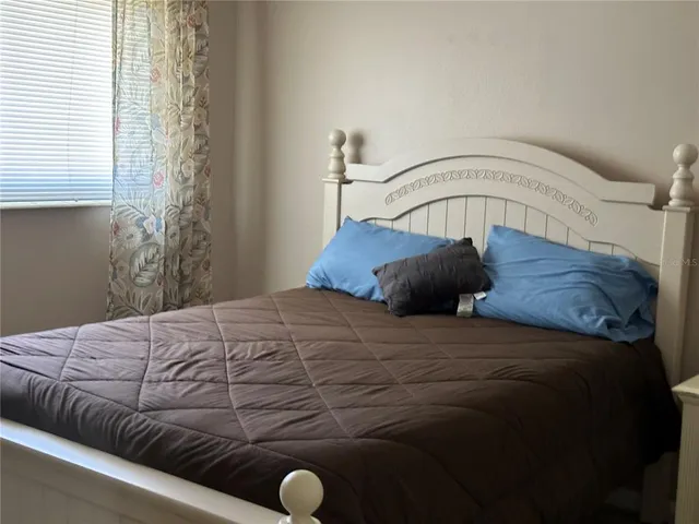 a bedroom with a bed and window